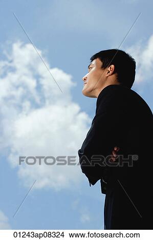 A man wearing a suit crosses his arms View Large Photo Image Picture - A man wearing a suit crosses his arms. Fotosearch