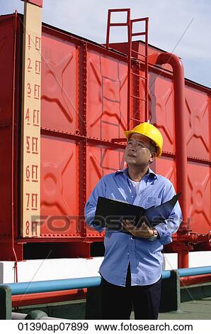A man with a yellow helmet at work outdoor View Large Photo Image Stock Photo - A man with a yellow helmet at work outdoor. Fotosearch