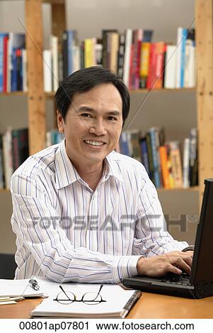 A man works on his laptop View Large Photo Image Stock Image - A man works on his laptop. Fotosearch