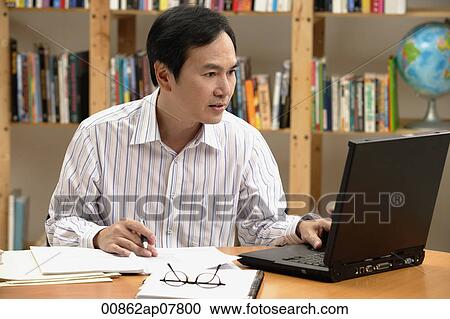 A man works on his laptop View Large Photo Image Stock Image - A man works on his laptop. Fotosearch