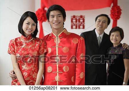A newlywed couple and their family smile at the camera together View Large Photo Image Stock Image - A newlywed couple and their family smile at the camera together. Fotosearch
