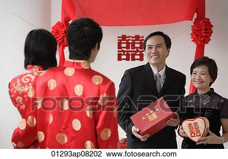 A newlywed couple are given gifts View Large Photo Image Stock Image - A newlywed couple are given gifts. Fotosearch