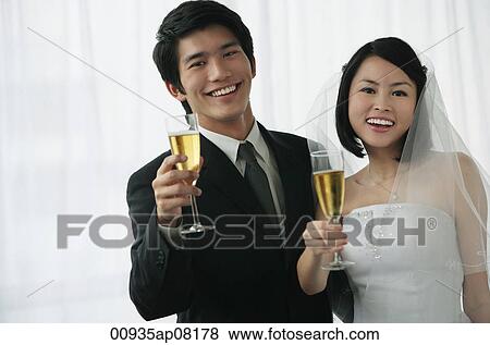 A newlywed couple smile at the camera View Large Photo Image Stock Photo - A newlywed couple smile at the camera. Fotosearch