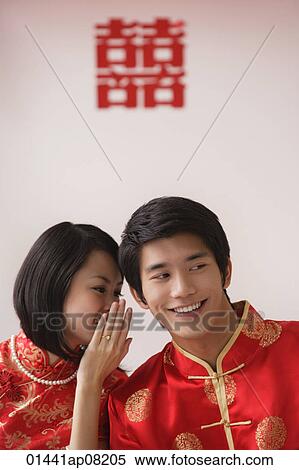 A newlywed couple whisper to each other View Large Photo Image Stock Photography - A newlywed couple whisper to each other. Fotosearch