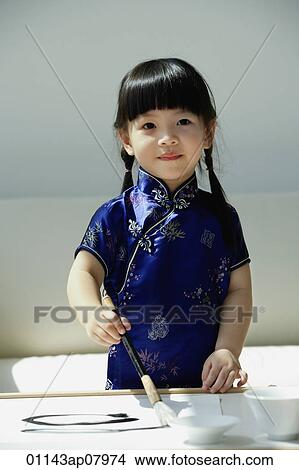 A small girl in blue silk cheongsam writing Chinese calligraphy View Large Photo Image Picture - A small girl in blue silk cheongsam writing Chinese calligraphy. Fotosearch