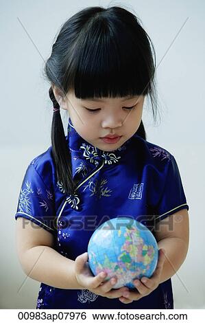A small girl in blue silk cheongsam holds a globe View Large Photo Image Stock Photograph - A small girl in blue silk cheongsam holds a globe. Fotosearch