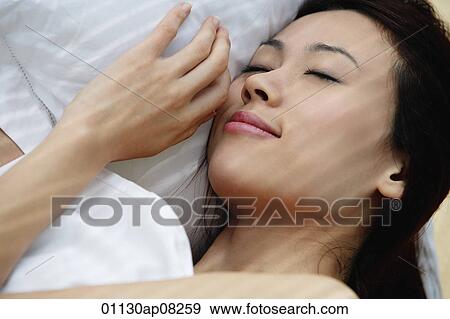 A woman asleep in bed View Large Photo Image Stock Photo - A woman asleep in bed. Fotosearch