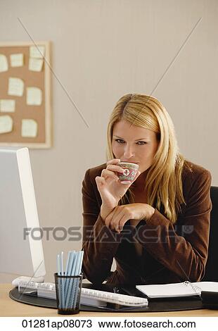 A woman looks at the camera as she drinks from a Chinese tea cup View Large Photo Image Stock Image - A woman looks at the camera as she drinks from a Chinese tea cup. Fotosearch