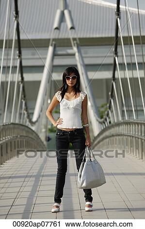 A woman on a bridge View Large Photo Image Stock Image - A woman on a bridge. Fotosearch