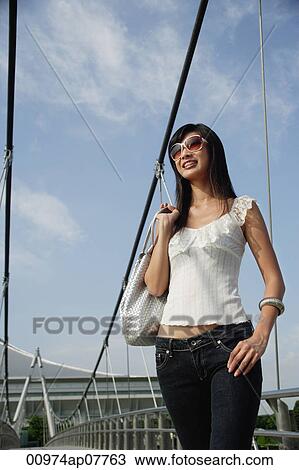 A woman on a bridge View Large Photo Image Stock Image - A woman on a bridge. Fotosearch