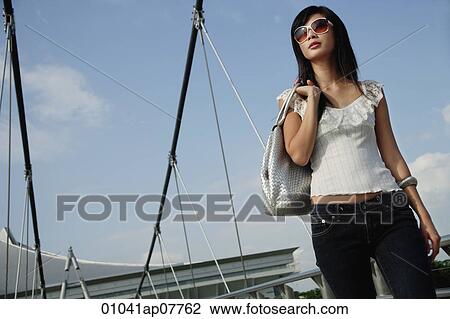 A woman on a bridge View Large Photo Image Stock Image - A woman on a bridge. Fotosearch