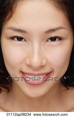 Picture - A woman smiles at the camera. Fotosearch