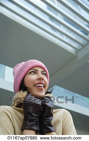 A woman tries to keep warm in a hat and gloves View Large Photo Image Stock Photography - A woman tries to keep warm in a hat and gloves. Fotosearch