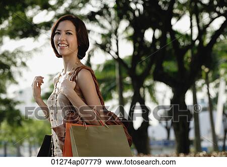 A woman with lots of shopping bags View Large Photo Image Stock Photo - A woman with lots of shopping bags. Fotosearch
