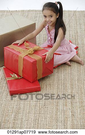 A young girl at a party with a birthday present View Large Photo Image Stock Photo - A young girl at a party with a birthday present. Fotosearch