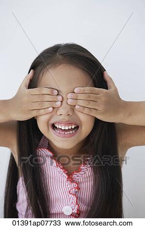 A young girl covers her eyes with her hands View Large Photo Image Stock Image - A young girl covers her eyes with her hands. Fotosearch