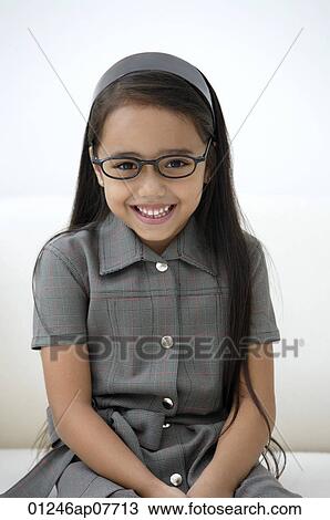 A young girl dressed in school uniform with glasses View Large Photo Image Stock Image - A young girl dressed in school uniform with glasses. Fotosearch