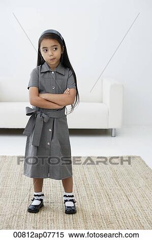 A young girl dressed in school uniform crosses her arms View Large Photo Image Stock Photography - A young girl dressed in school uniform crosses her arms. Fotosearch