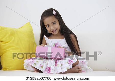A young girl with a birthday present View Large Photo Image Stock Image - A young girl with a birthday present. Fotosearch