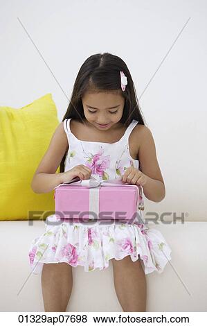A young girl with a birthday present View Large Photo Image Stock Photo - A young girl with a birthday present. Fotosearch