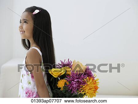 A young girl with a bunch of flowers View Large Photo Image Stock Photo - A young girl with a bunch of flowers. Fotosearch
