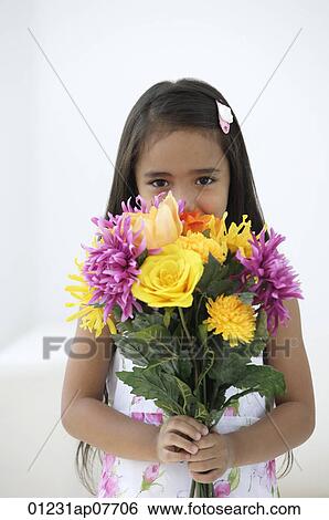 A young girl with a bunch of flowers View Large Photo Image Stock Photograph - A young girl with a bunch of flowers. Fotosearch
