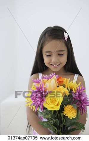 A young girl with a bunch of flowers View Large Photo Image Stock Photography - A young girl with a bunch of flowers. Fotosearch