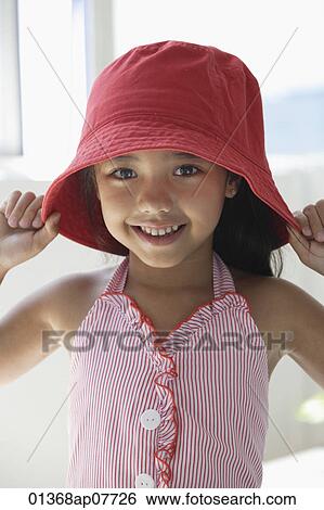 Stock Photograph - A young girl with a red hat. Fotosearch