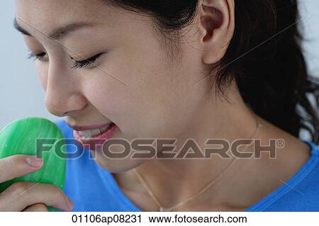 Stock Image - A young holds a bar of soap. Fotosearch