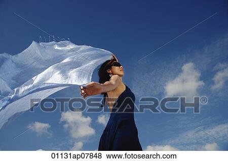 A young woman dances in the wind with a veil View Large Photo Image Stock Photo - A young woman dances in the wind with a veil. Fotosearch