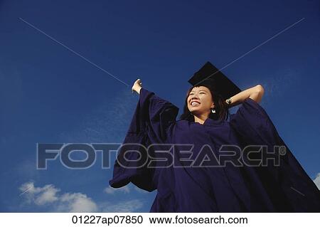 A young woman dressed in her graduation gown View Large Photo Image Stock Image - A young woman dressed in her graduation gown. Fotosearch