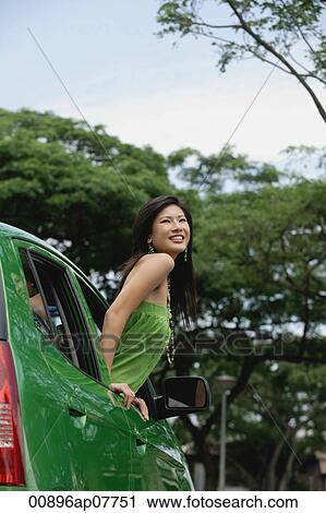 A young woman leans out of the window of a car View Large Photo Image Stock Image - A young woman leans out of the window of a car. Fotosearch