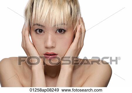 A young woman looks frightened as she looks at the camera View Large Photo Image Stock Photo - A young woman looks frightened as she looks at the camera. Fotosearch