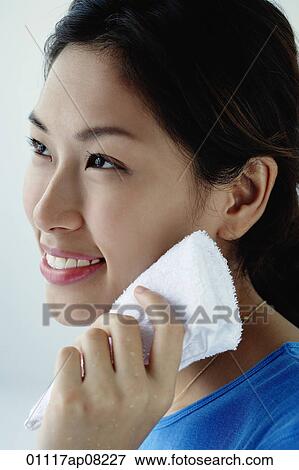 A young woman washes her face View Large Photo Image Stock Photo - A young woman washes her face. Fotosearch
