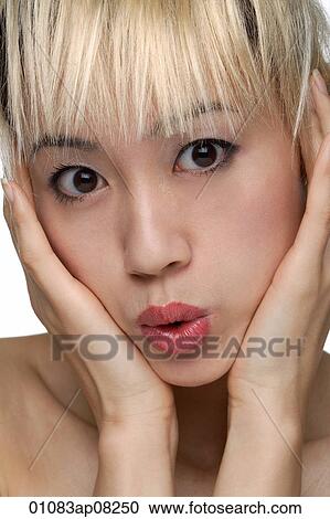A young woman with dyed blonde hair looks at the camera View Large Photo Image Stock Image - A young woman with dyed blonde hair looks at the camera. Fotosearch