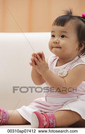 Baby Girl sitting and holding hands in prayer View Large Photo Image Stock Image - Baby Girl sitting and holding hands in prayer. Fotosearch