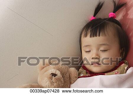 baby girl sleeping with teddy bear under blanket View Large Photo Image Stock Photo - baby girl sleeping with teddy bear under blanket. Fotosearch