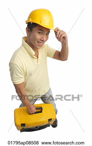 Stock Photo - Builder with tool box smiling at camera. Fotosearch