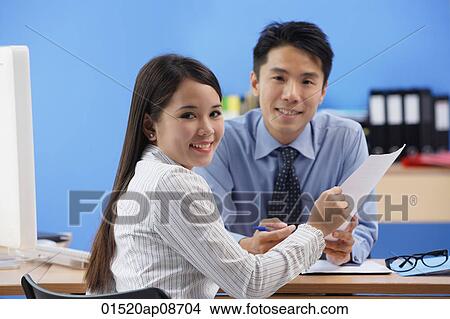 Businessman and woman smiling at camera View Large Photo Image Picture - Businessman and woman smiling at camera. Fotosearch