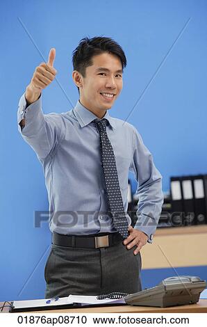 Businessman giving thumbs up at camera View Large Photo Image Stock Image - Businessman giving thumbs up at camera. Fotosearch