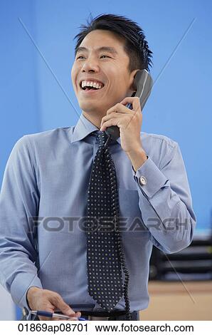 Businessman laughing while on the phone View Large Photo Image Stock Image - Businessman laughing while on the phone. Fotosearch