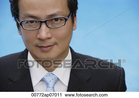 Businessman looking at camera, head shot View Large Photo Image Stock Image - Businessman looking at camera, head shot. Fotosearch