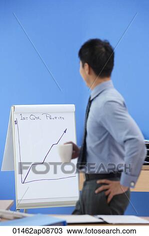 Businessman looking at statistics View Large Photo Image Stock Image - Businessman looking at statistics. Fotosearch