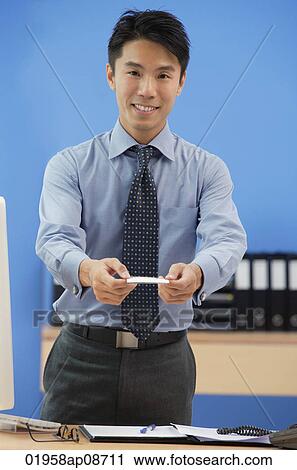 Businessman offering his business card View Large Photo Image Stock Image - Businessman offering his business card. Fotosearch