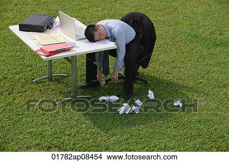 Businessman resting head on desk View Large Photo Image Picture - Businessman resting head on desk. Fotosearch
