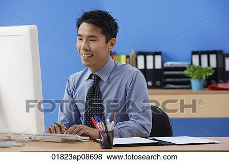 Businessman working at computer View Large Photo Image Stock Photo - Businessman working at computer. Fotosearch