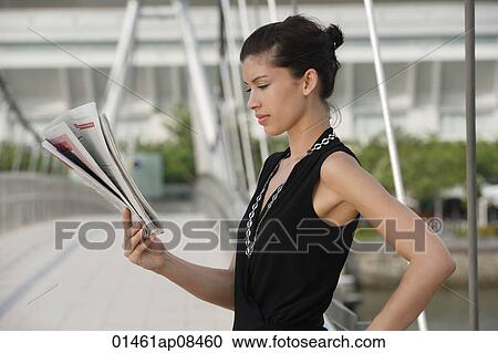 Businesswoman reading newspaper View Large Photo Image Stock Image - Businesswoman reading newspaper. Fotosearch