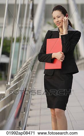 Businesswoman talking on the mobile phone View Large Photo Image Stock Image - Businesswoman talking on the mobile phone. Fotosearch