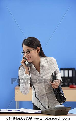 Businesswoman talking on the phone View Large Photo Image Stock Photo - Businesswoman talking on the phone. Fotosearch