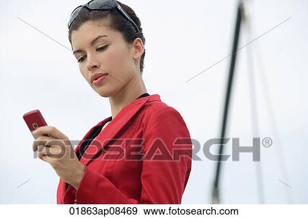 Businesswoman using mobile phone View Large Photo Image Stock Photo - Businesswoman using mobile phone. Fotosearch